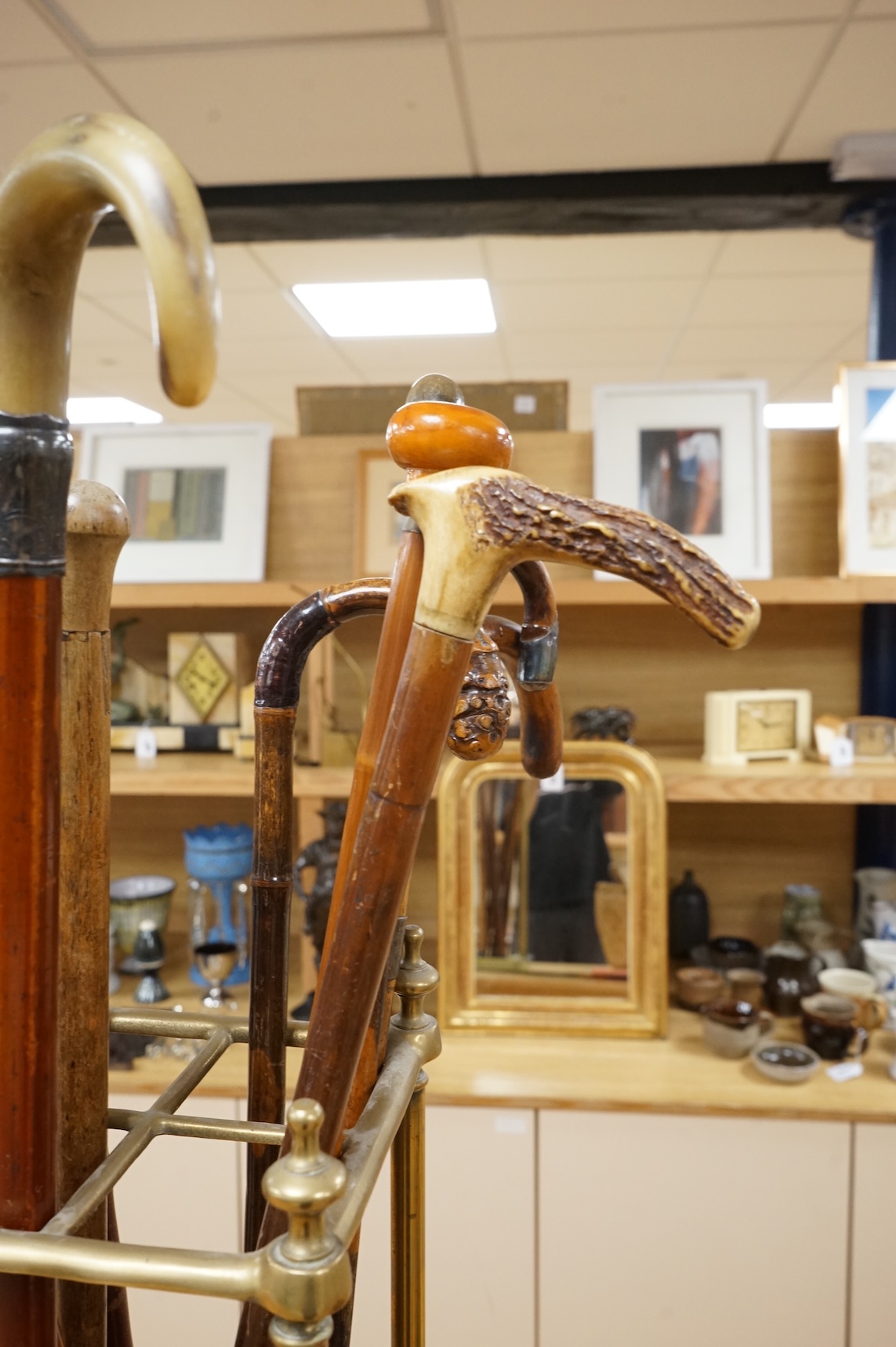 A collection of various walking sticks, some silver mounted and a brass stick stand, 67cm high